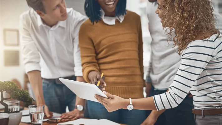Group, people and tablet for data analysis in company as web developer in digital agency, workshop or office. Team, business meeting and collaboration with diversity, growth or career in brand design.