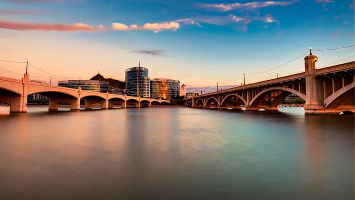 A view of Tempe bridges over the water at sunset