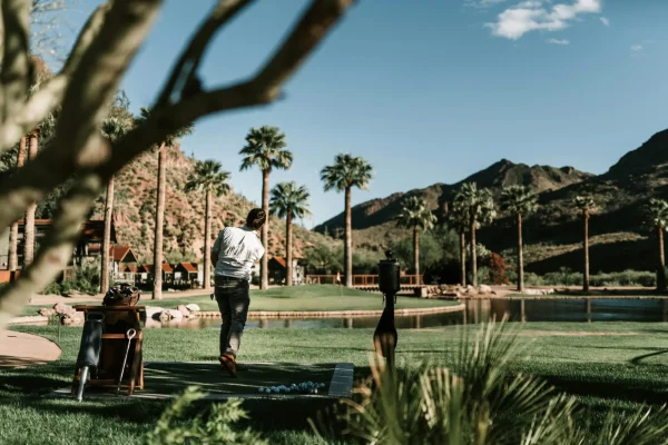 man golfing in scottsdale arizona with mountains in the distance